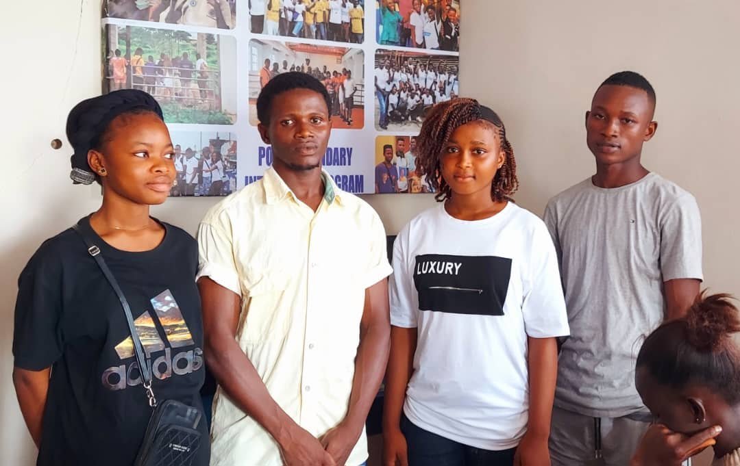 Young participants standing together in a classroom